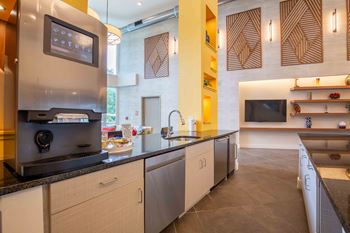 a kitchen with stainless steel appliances and a counter top at Woodmore Grand Apartments in Bowie, MD 20721